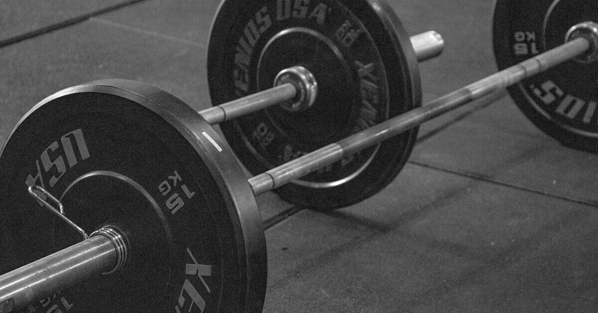 A loaded barbell on a gym floor