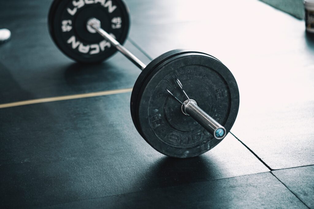 A loaded barbell lying on a gym floor - Bent Barbells 101