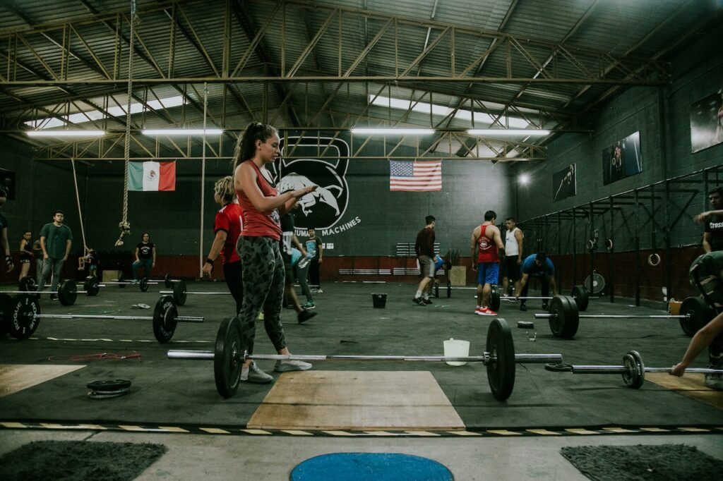 Lifters at a CrossFit gym performing exercises multipurpose barbells
