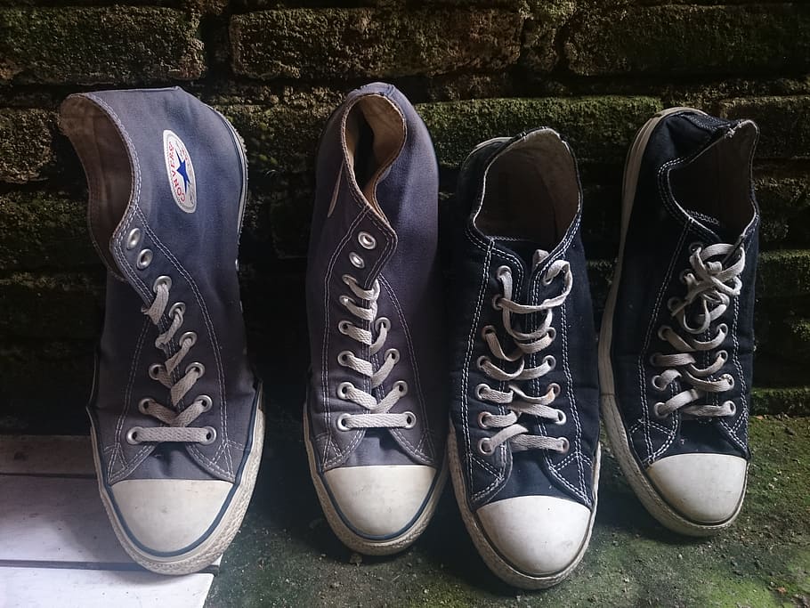 A pair of Converse Chuck Taylor High Tops and Low Tops sitting next to each other 