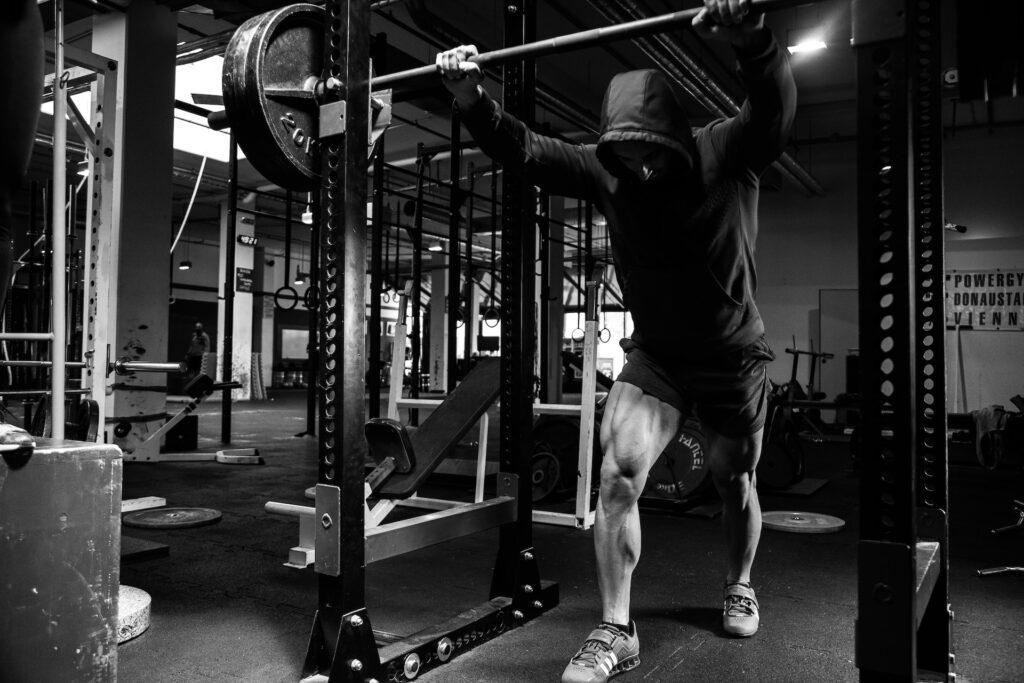 A lifter in a power rack preparing to squat