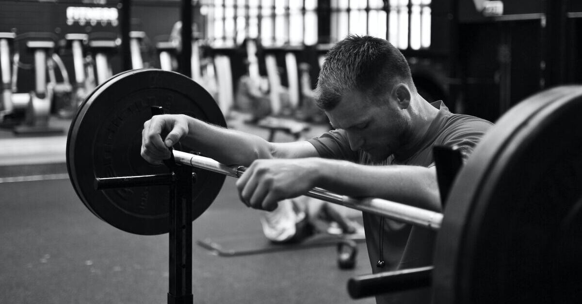 A lifter leaning on a barbell